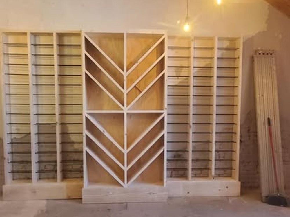 Custom shelving unit with chevron-pattern center panel, in progress