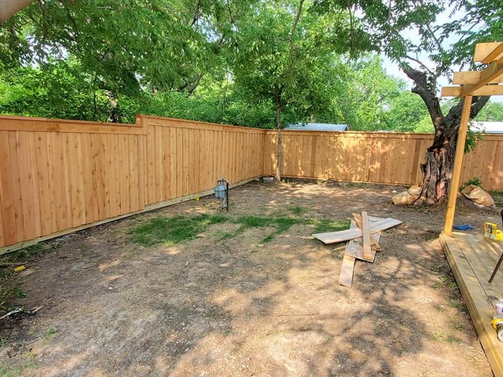 Freshly built natural cedar fence enclosing backyard