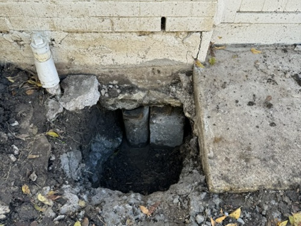 Excavating access hole at foundation pier