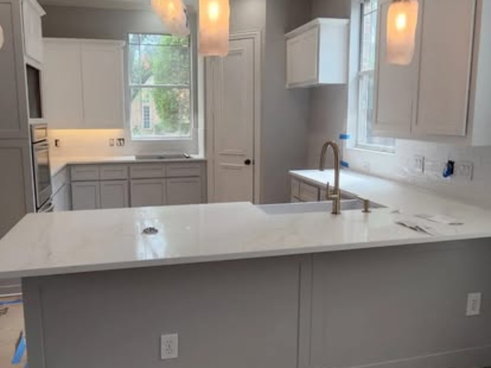 Finished kitchen with new pendant lighting and hardwood floors