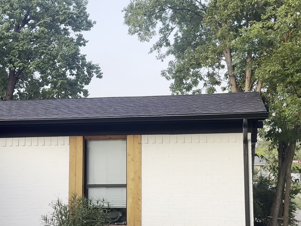 Finished roof edge against white brick exterior